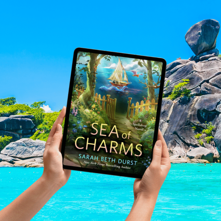 Ereader in front of beach cover is of sea of charms being held up